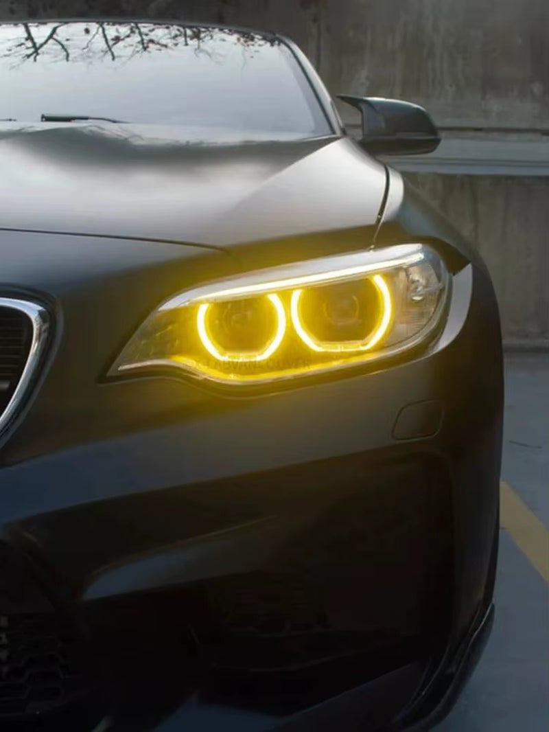 Yellow DRL angel eyes on a pre-LCI F87 M2 at night